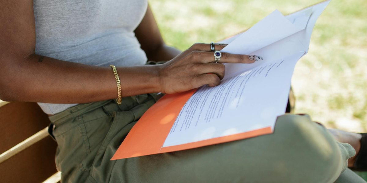 An investor carefully reviews documents, seeking trustworthy insights for a significant decision.