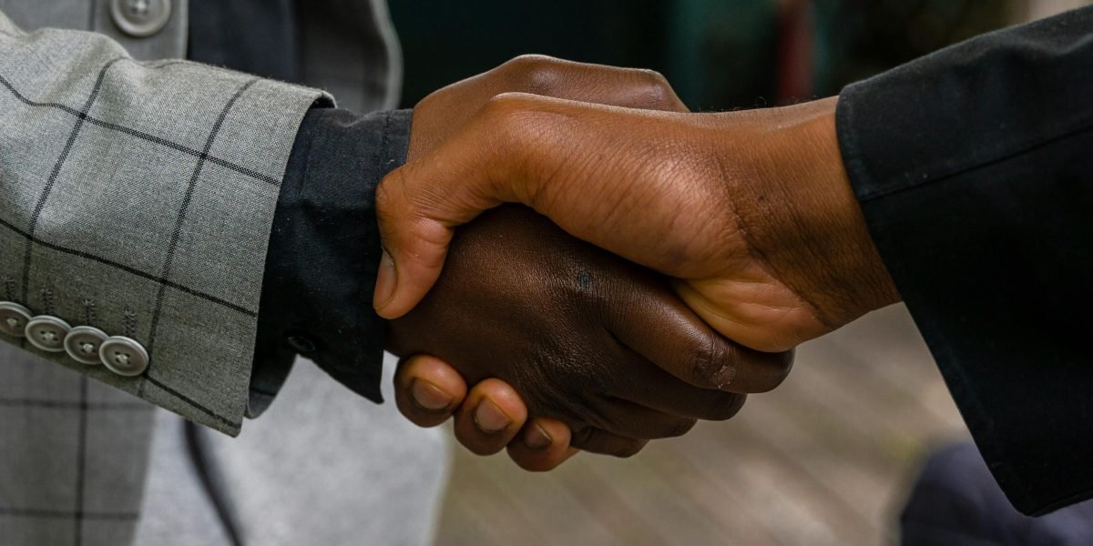 A handshake symbolizes a successful partnership and the sealing of an investment deal.