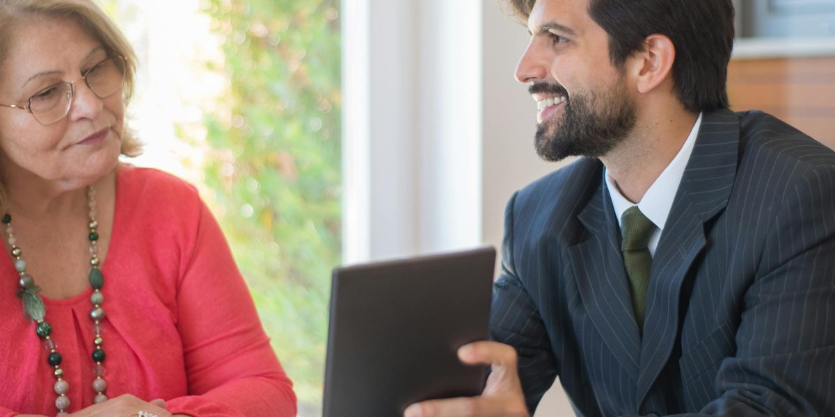 A professional real estate agent advising a client on luxury property investments.