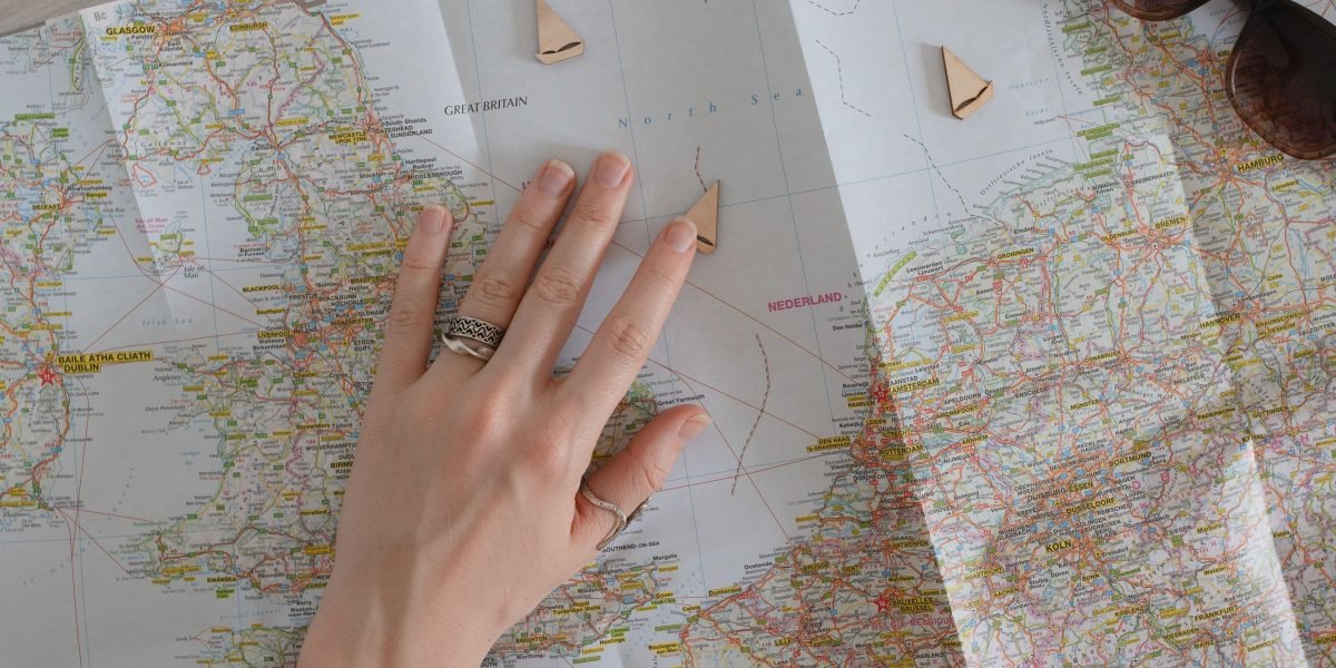 An individual thoughtfully reviewing notes and a roadmap, symbolizing strategic career planning and goal setting.