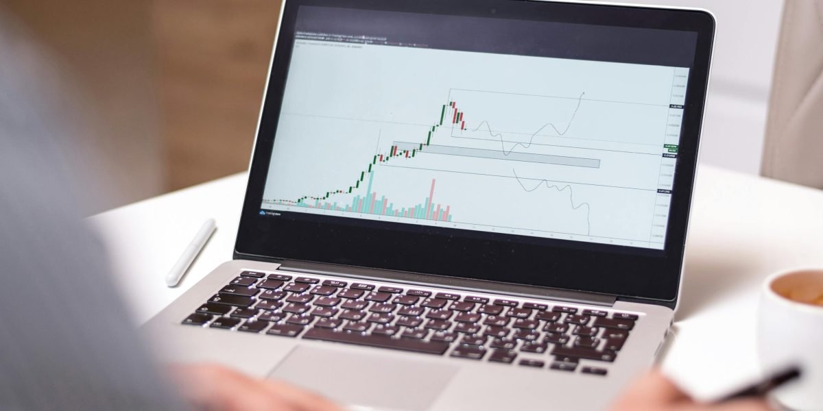 A high net worth individual diligently comparing various market data points for investment opportunities.