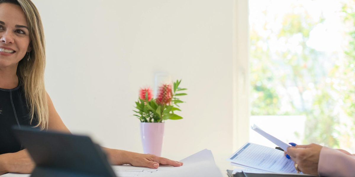 A client in a professional setting having a focused discussion with a real estate advisor.