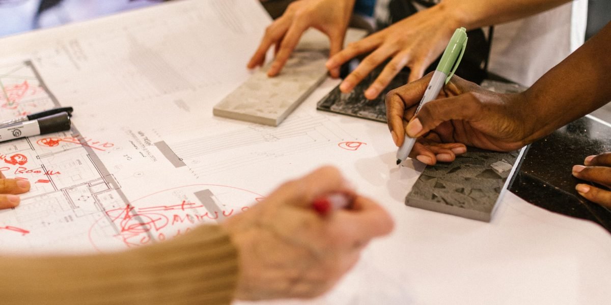 A team of real estate professionals collaborating on project plans, reflecting the development of iconic communities.