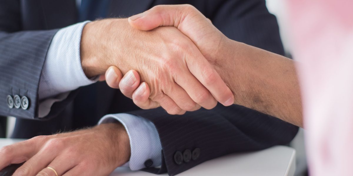 A handshake symbolizing trust and agreement after a successful meeting with a reliable agency.