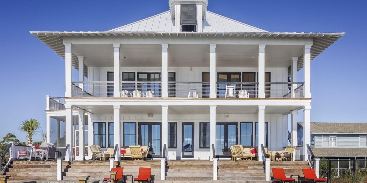 A couple standing on a balcony, looking out at a stunning luxury property view, envisioning their future.