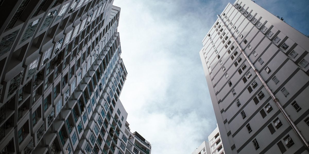 A person looking out at a dynamic city skyline with modern architecture and new developments.