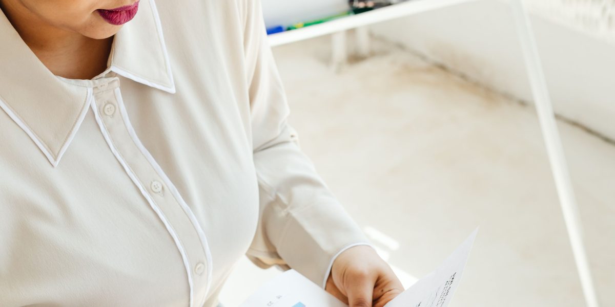 A person reviews investment documents, embodying the critical decisions high-net-worth buyers face in Dubai's luxury property market.
