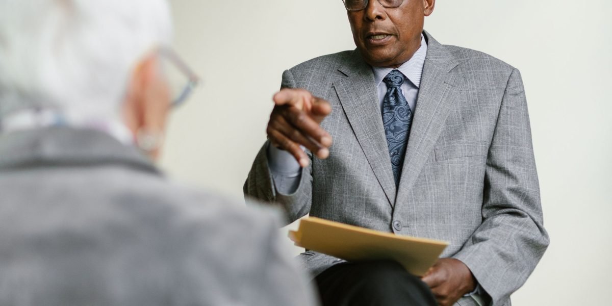 A professional discussing investment strategies with an expert advisor in a modern office setting.