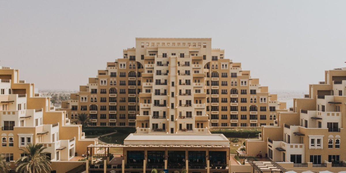 A couple looks out at a beautiful coastal landscape, envisioning their future luxury home in Ras Al Khaimah.
