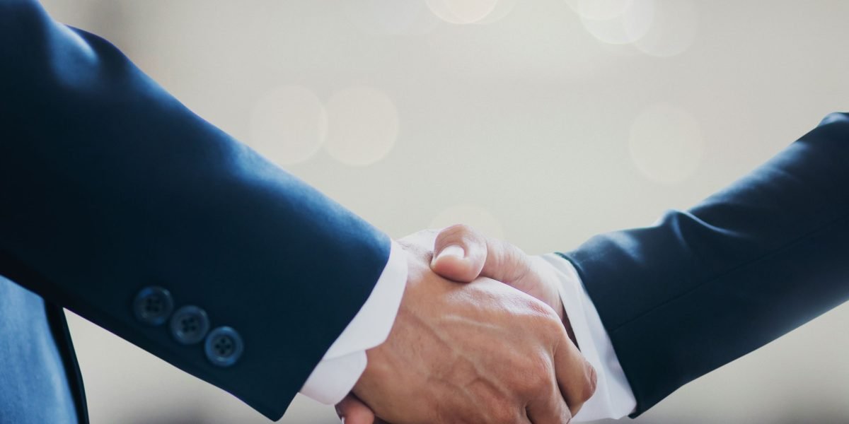 A scene depicting a handshake between professionals, symbolizing a trusted partnership in a high-value deal.