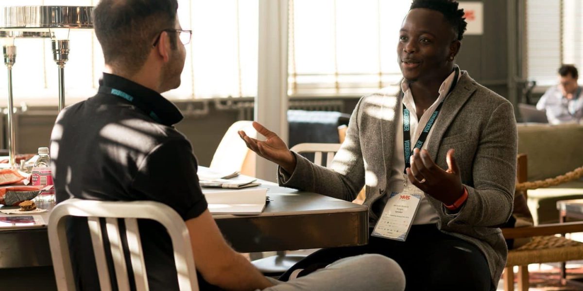 A scene showing a mentor providing clear guidance to a mentee, reflecting the value of expert advice.
