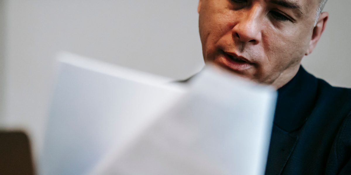 A scene of a person meticulously reviewing documents, emphasizing the importance of thorough verification.