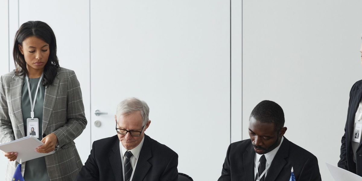 A scene of a diverse group of professionals in a meeting, representing international buyers discussing complex legal structures.