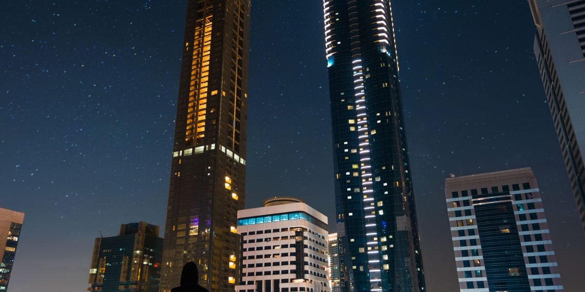 A person confidently looking out over the impressive Dubai skyline, symbolizing aspiration and high-net-worth opportunities.