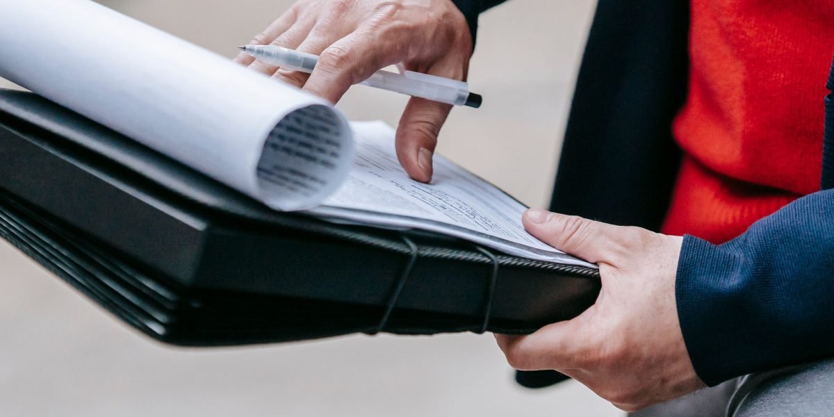 A diligent person meticulously reviewing important documents, reflecting the need for careful due diligence in real estate investment.