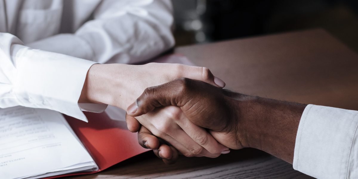 A professional handshake signifying the successful completion of a real estate deal, representing trust and a smooth transaction.