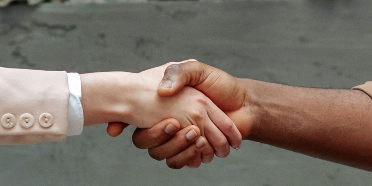 A handshake symbolizes a successful agreement between a client and a real estate professional.
