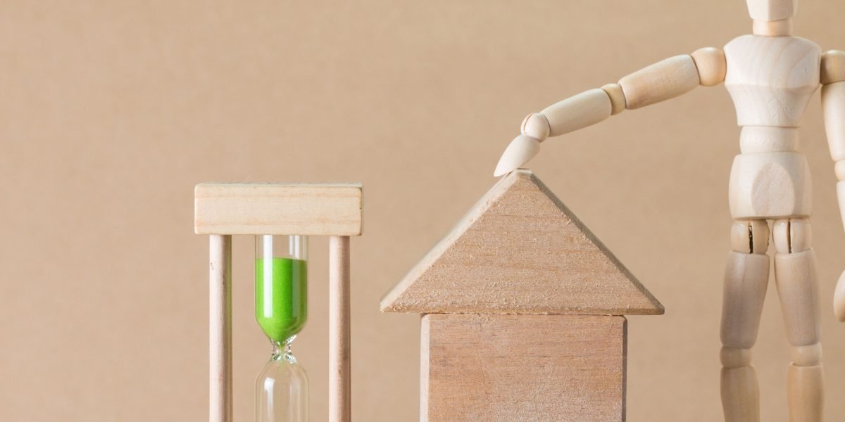 An investor thoughtfully considers future opportunities in the luxury real estate market.