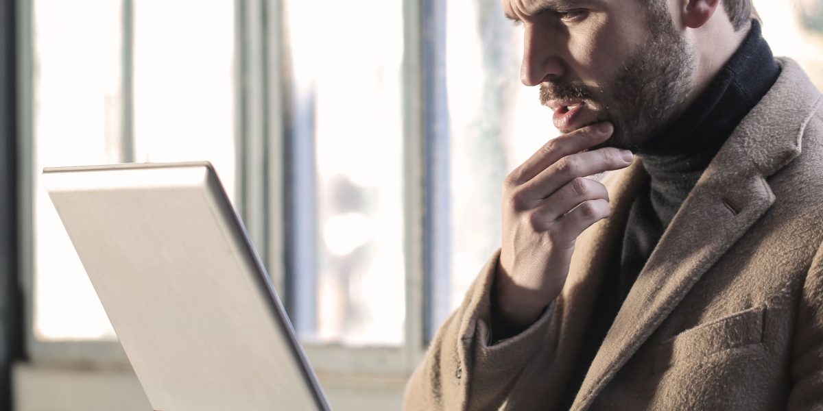 A person deeply contemplating a significant investment decision, representing careful thought and risk assessment.