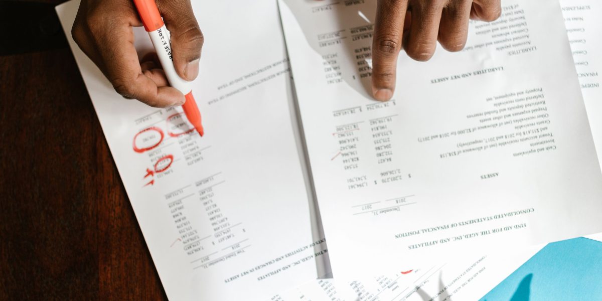 A person carefully reviewing documents and reports, symbolizing the critical process of due diligence for property investment.
