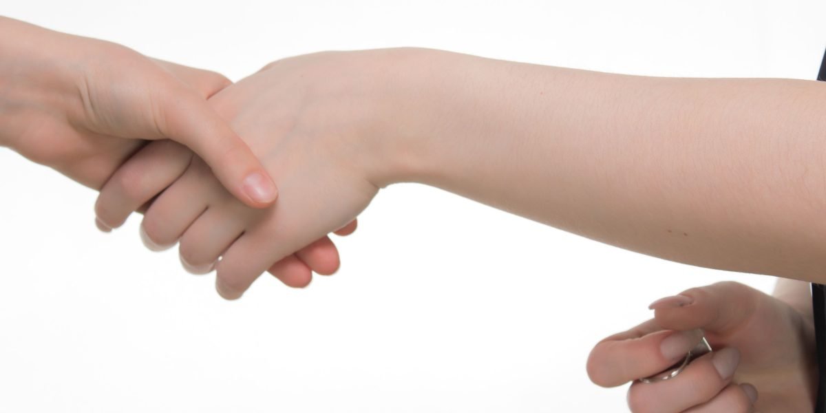 A handshake symbolizes a successful agreement, highlighting trust and partnership in a high-value real estate transaction.