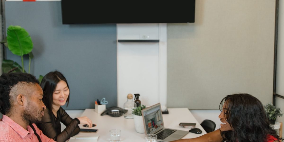 A team of professionals collaborating to compare different real estate investment options and strategies.