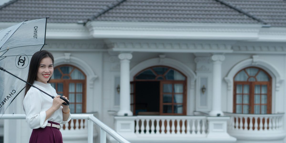 A person reviewing property documents, symbolizing the careful consideration needed for luxury real estate investment.