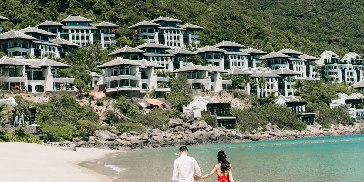 A couple looks out from a modern luxury villa balcony, embodying the dream of high-end property ownership in Dubai.
