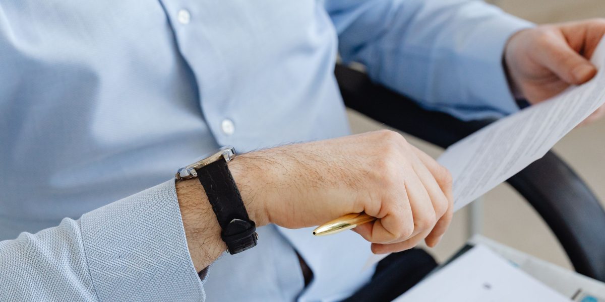 A confident professional reviews important documents, symbolizing informed decision-making in luxury investments.